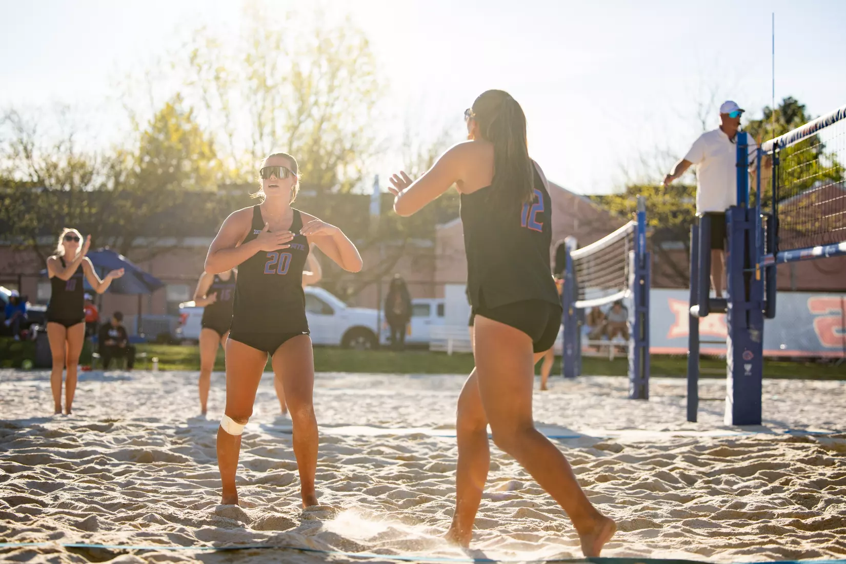 Boise State Beach Volleyball partners celebrating a point on the sand