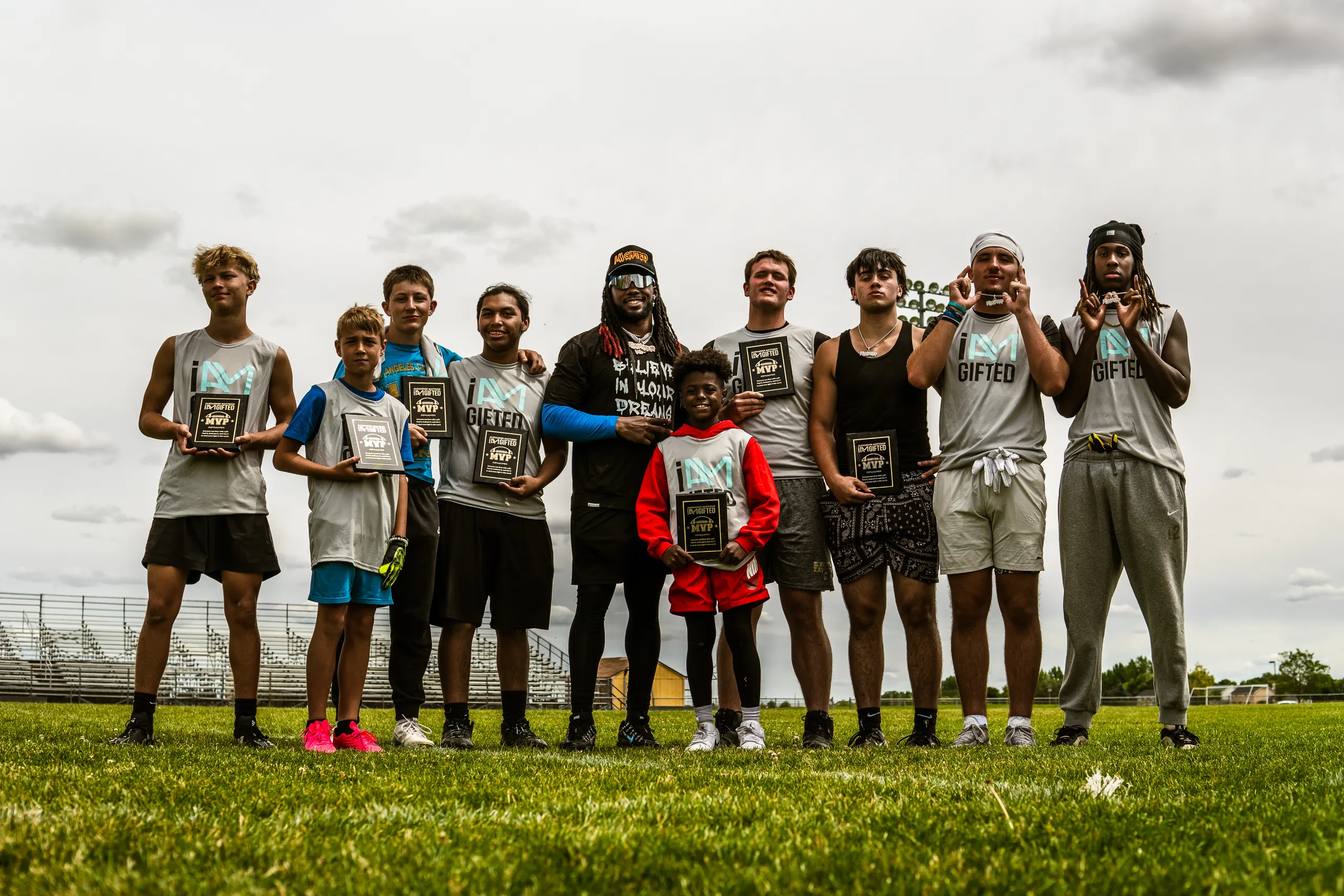 Alexander Mattison coaching young athletes on the field at his I AM GIFTED football camp
