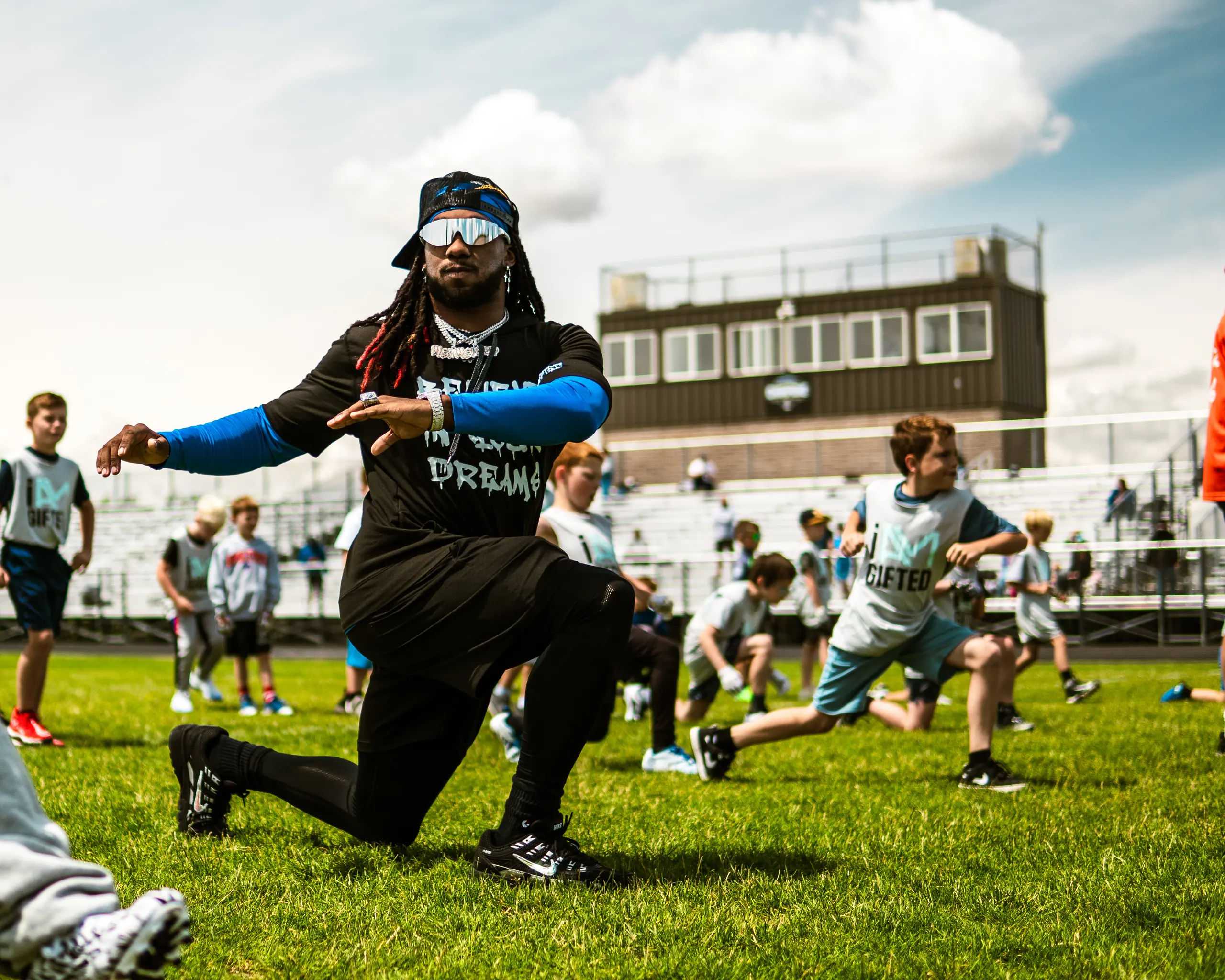 Alexander Mattison coaching young athletes at his free I AM GIFTED football camp