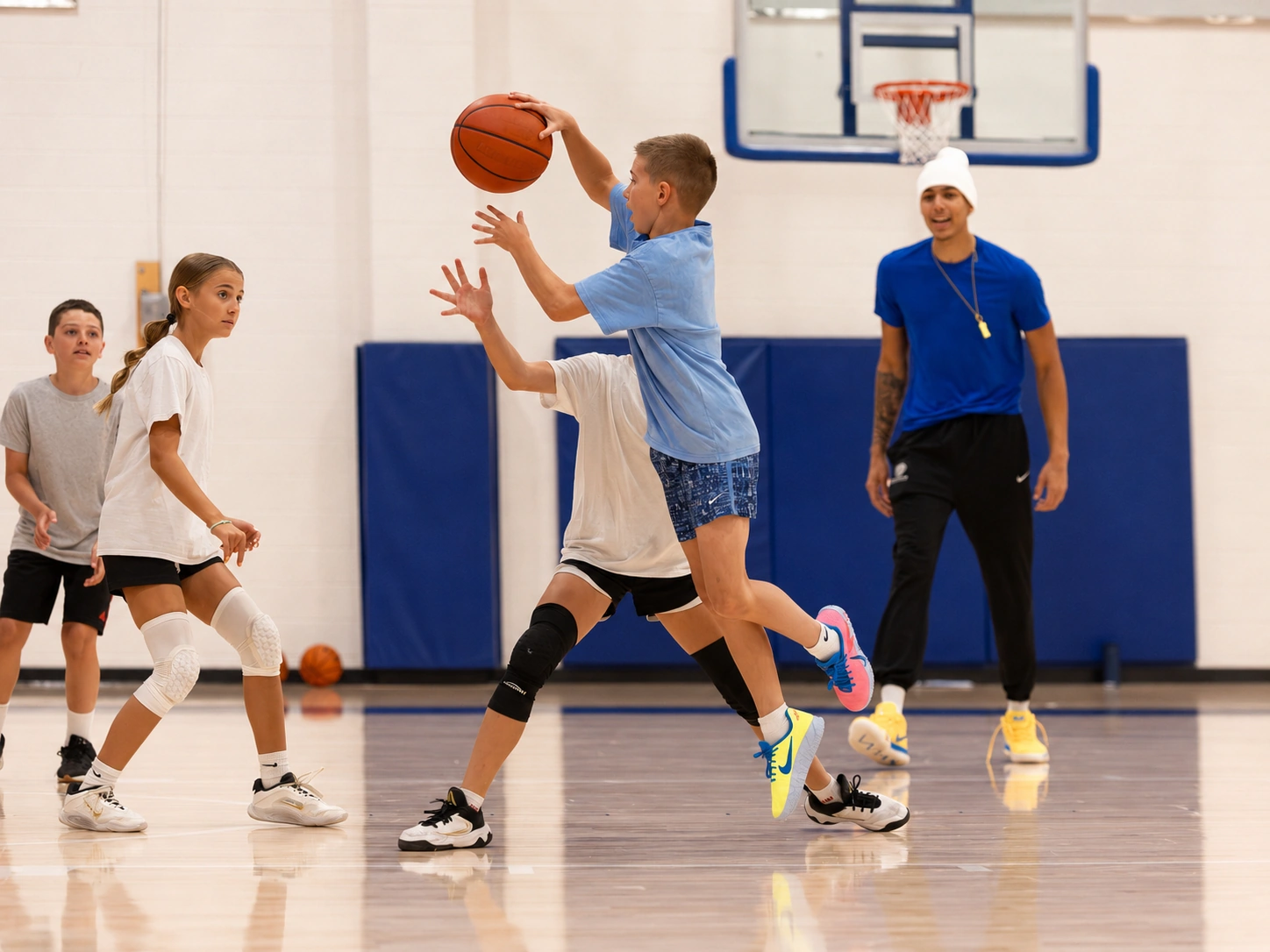Campers running a station with a Boise State player at a past camp