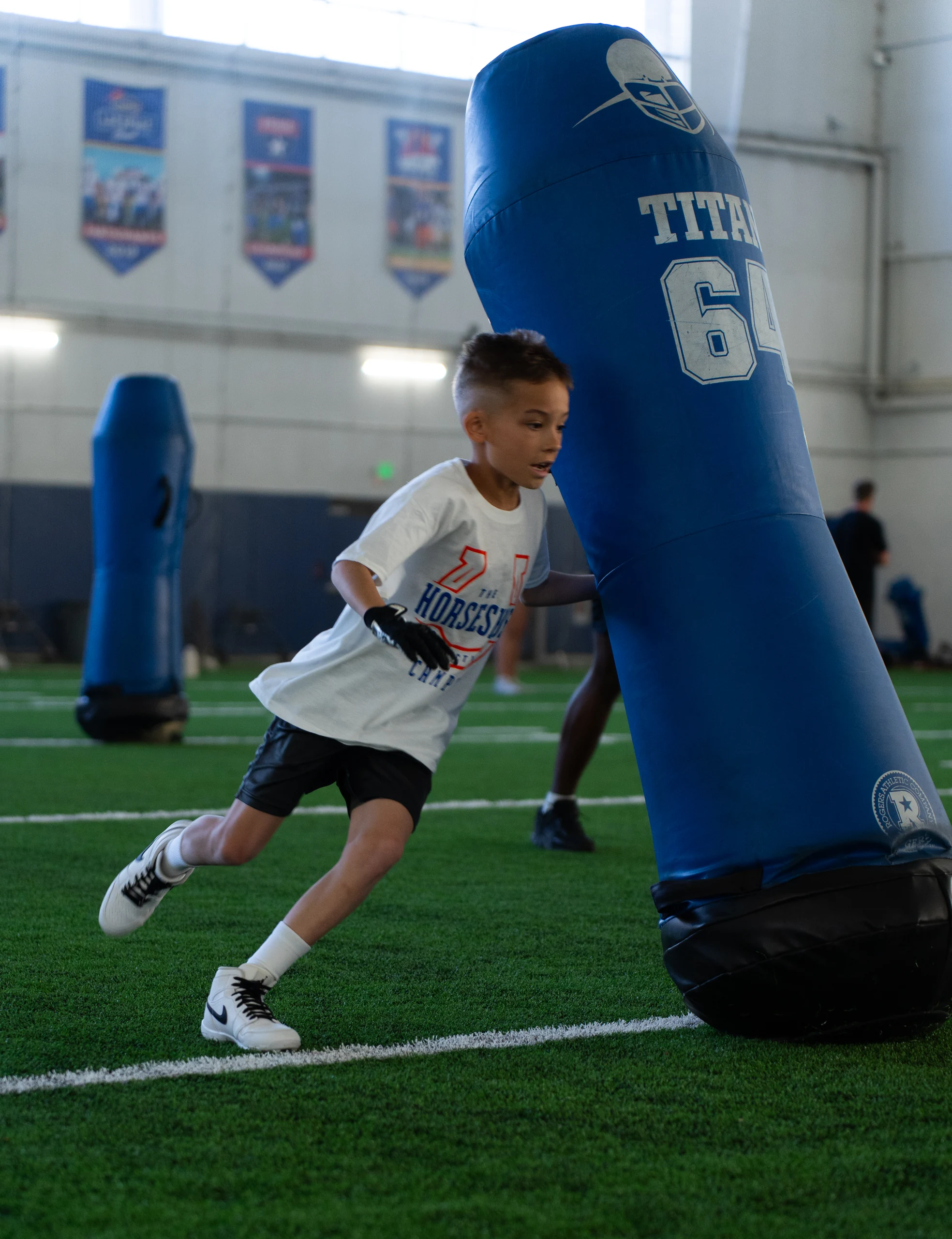 Athlete at a past Horseshoe football camp with Boise State players