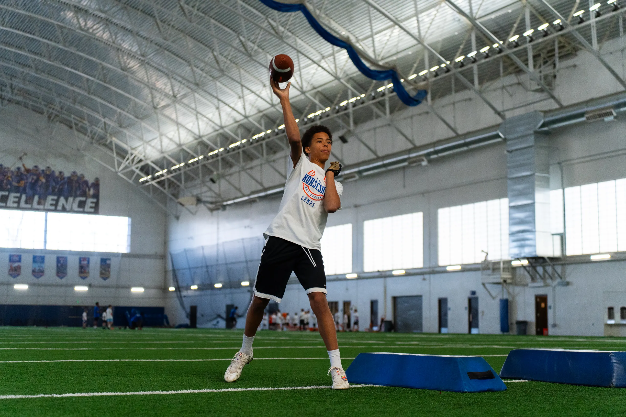Boise State players coaching campers at a past Horseshoe football camp
