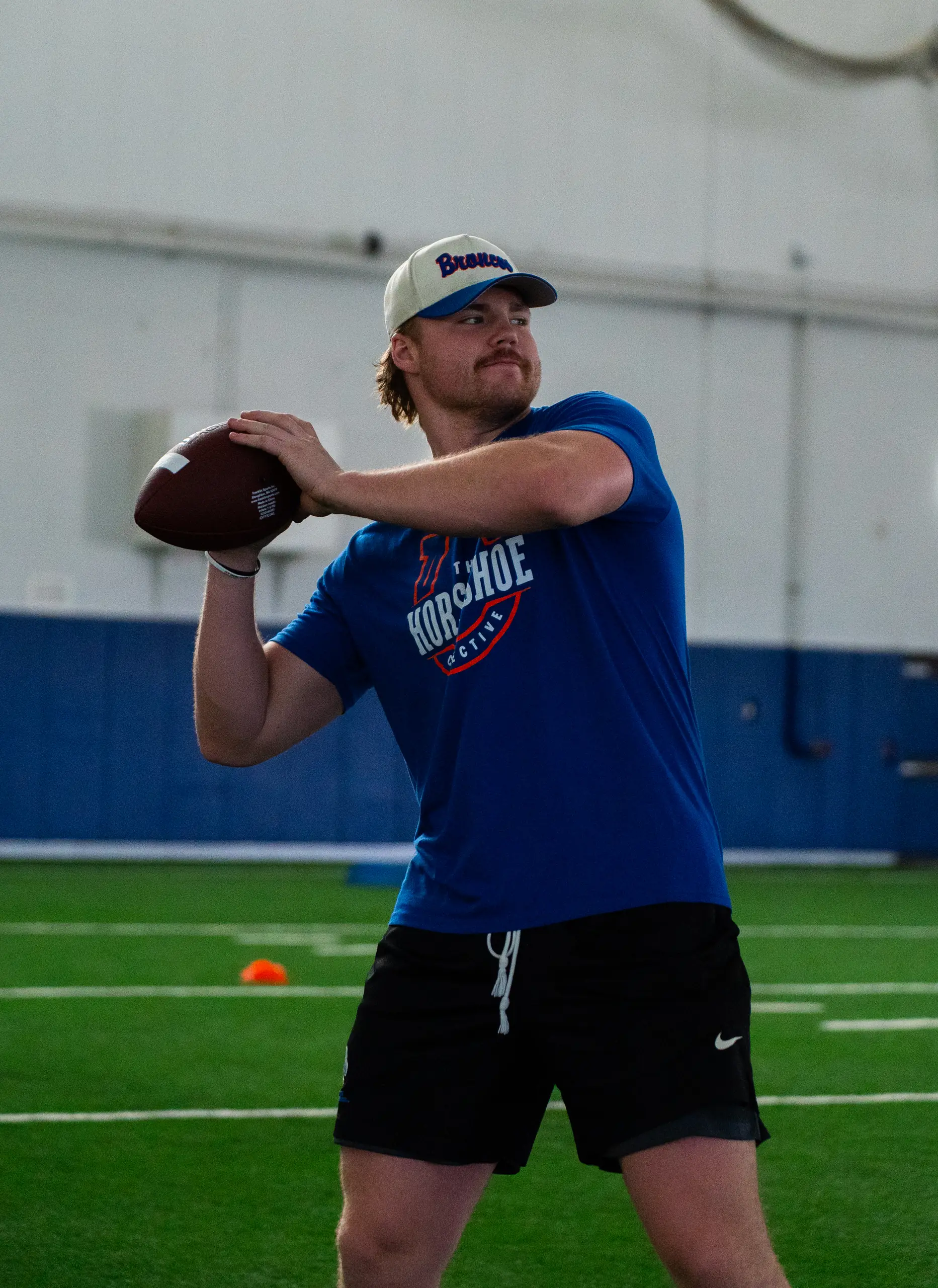 Camper in a stance at a past Horseshoe football camp with Boise State players