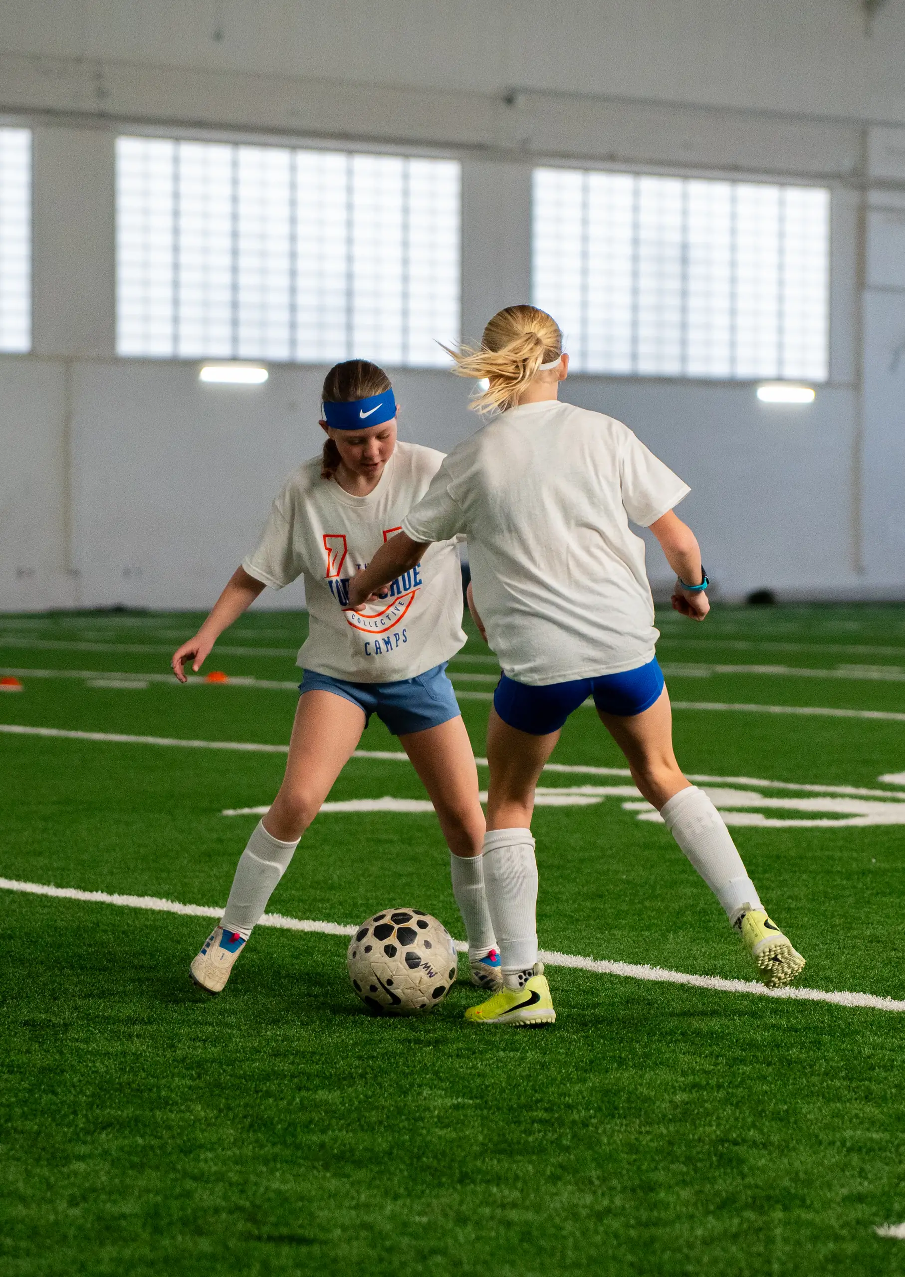 Two campers shielding and challenging for the ball in a small-sided drill
