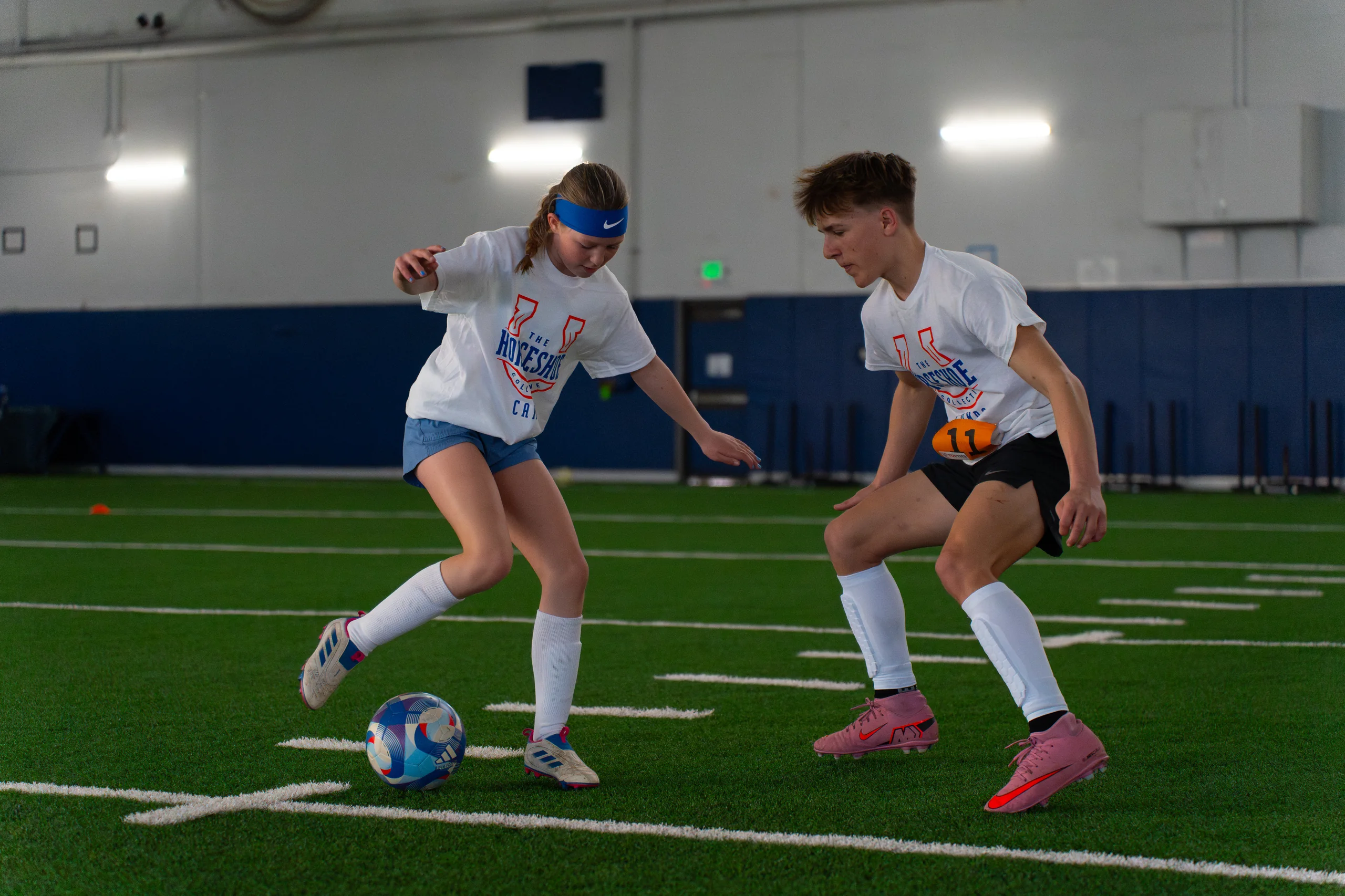 Two campers competing for the ball at a past Horseshoe soccer camp