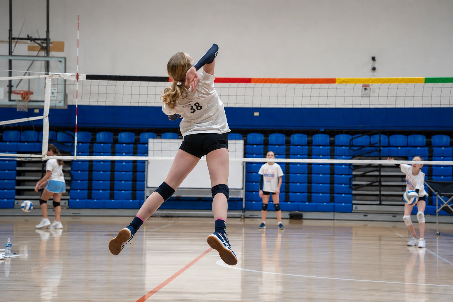 Athletes training at a past Bronco Volleyball clinic