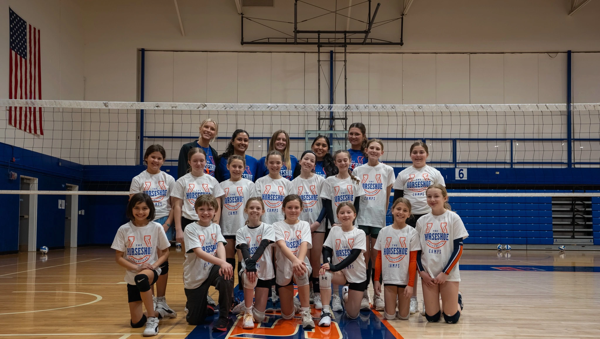 Boise State players coaching campers at the net