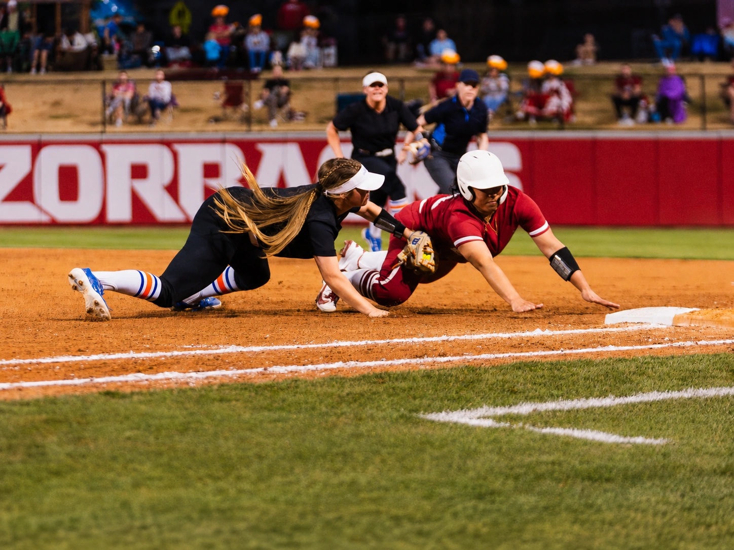Boise State Softball infielder applying a tag at third base