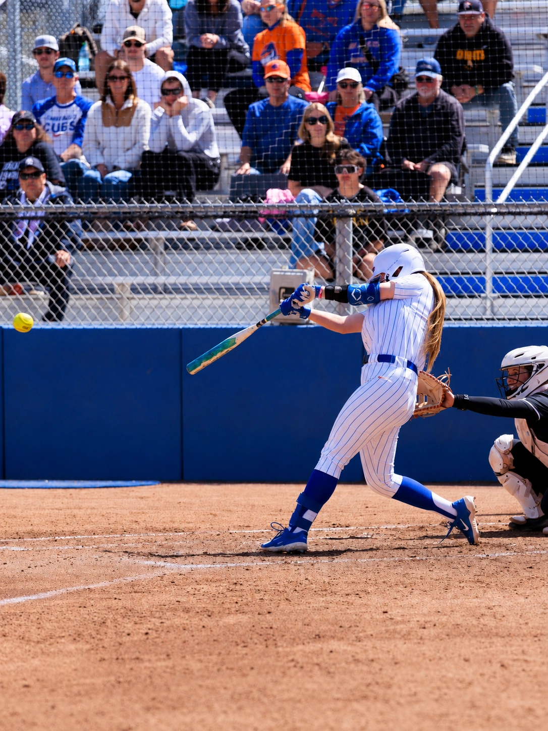 Kate Penberthy driving a pitch at the plate for Boise State Softball