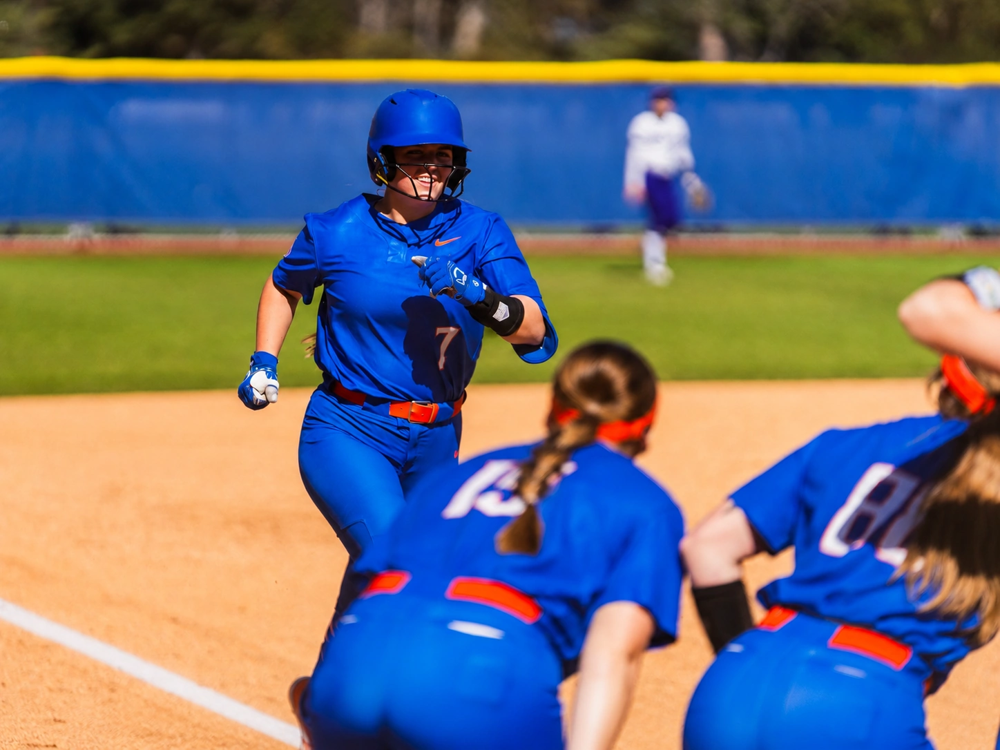 Boise State Softball runner rounding the bases toward her teammates