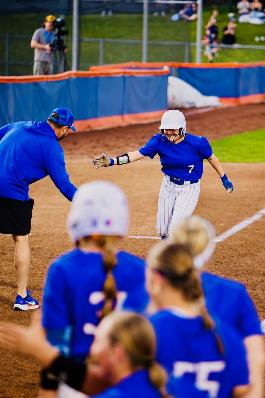 Boise State Softball teammates waiting at home plate to greet a runner