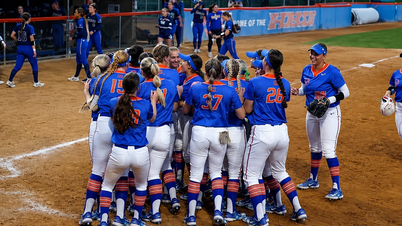 Boise State Softball players celebrating together at home plate